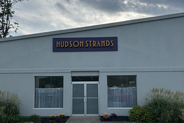 Hudson Strands storefront with indigo and gold signage, Wappingers Falls